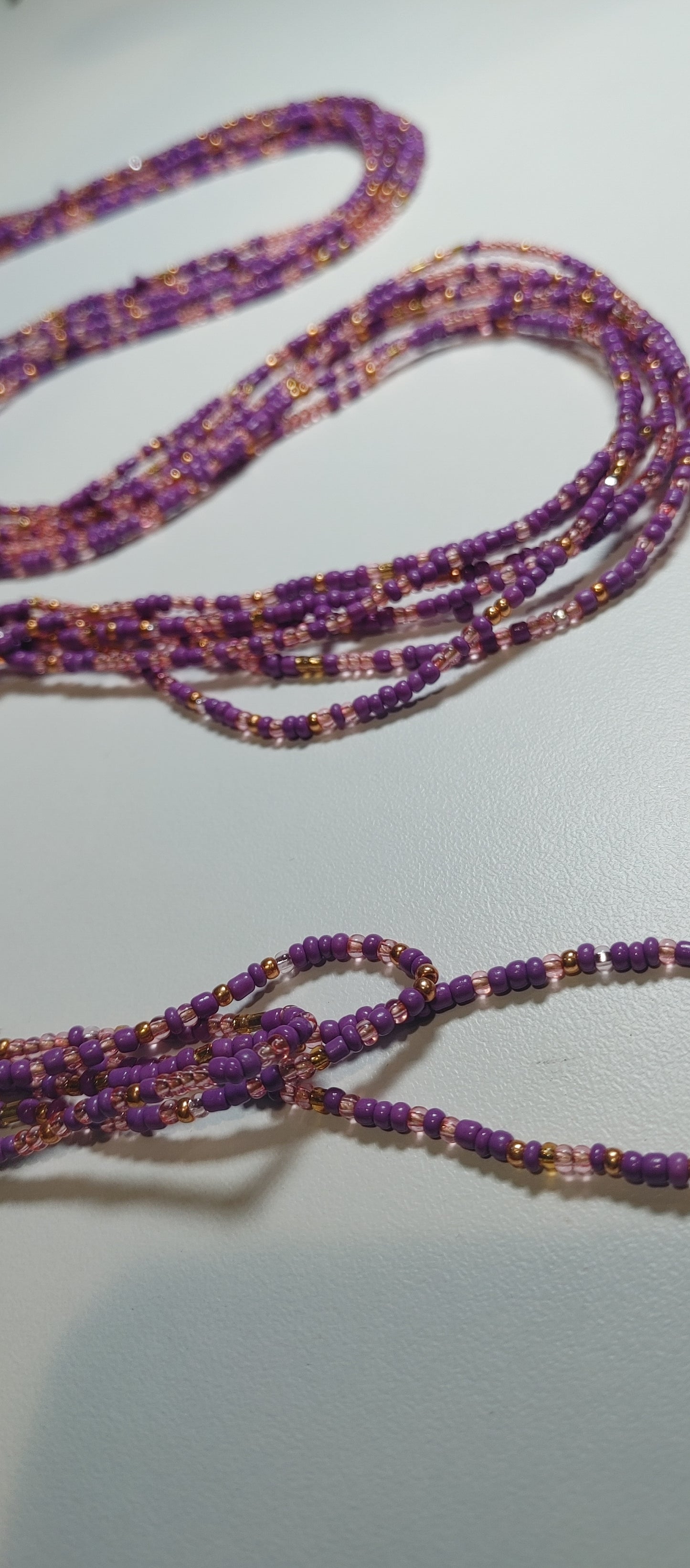 Purple and gold waistbeads.